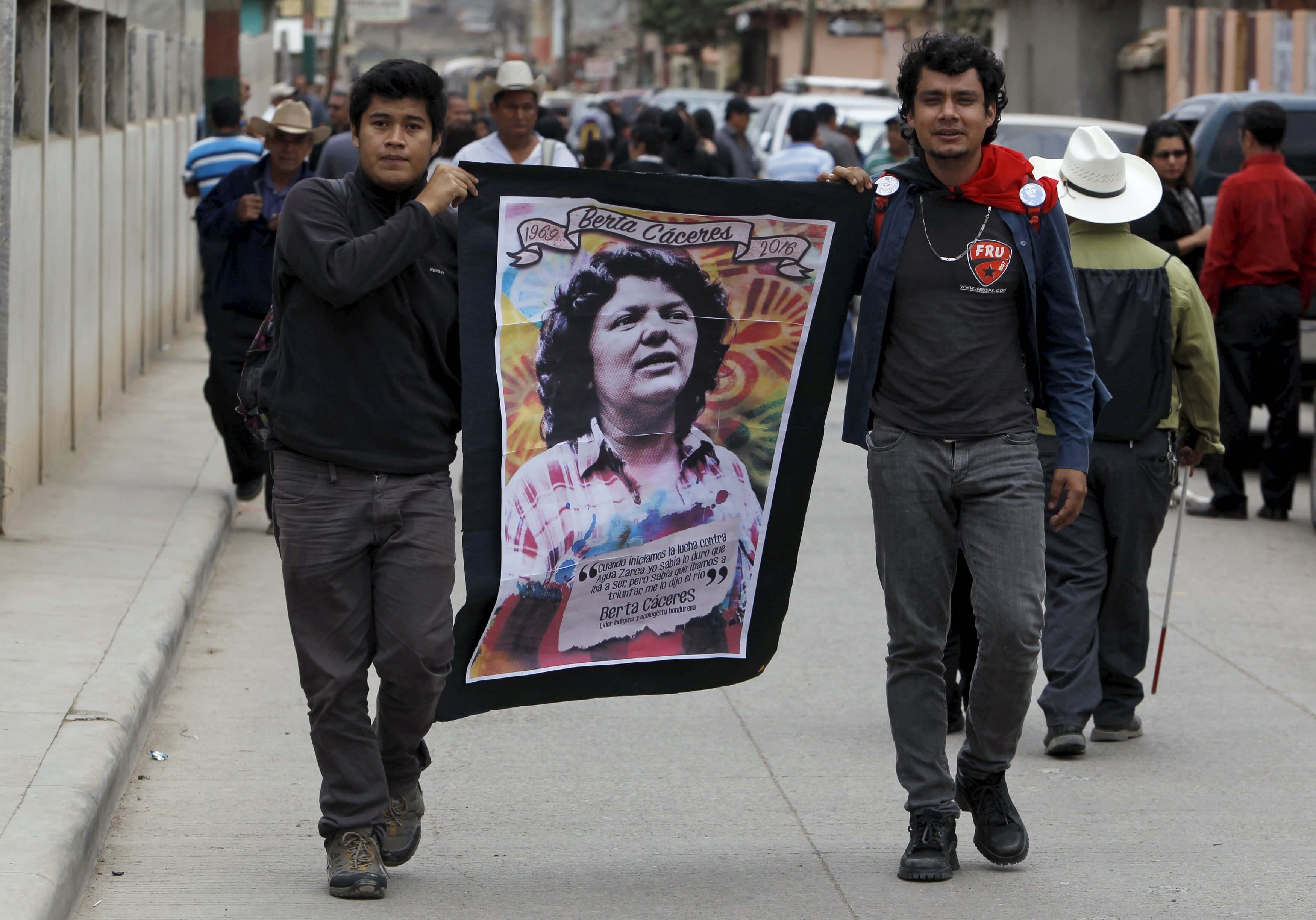 Supporters carry a banner with an image of slain environmental rights activist Berta Caceres along a street during her funeral in the town of La Esperanza, outside Tegucigalpa